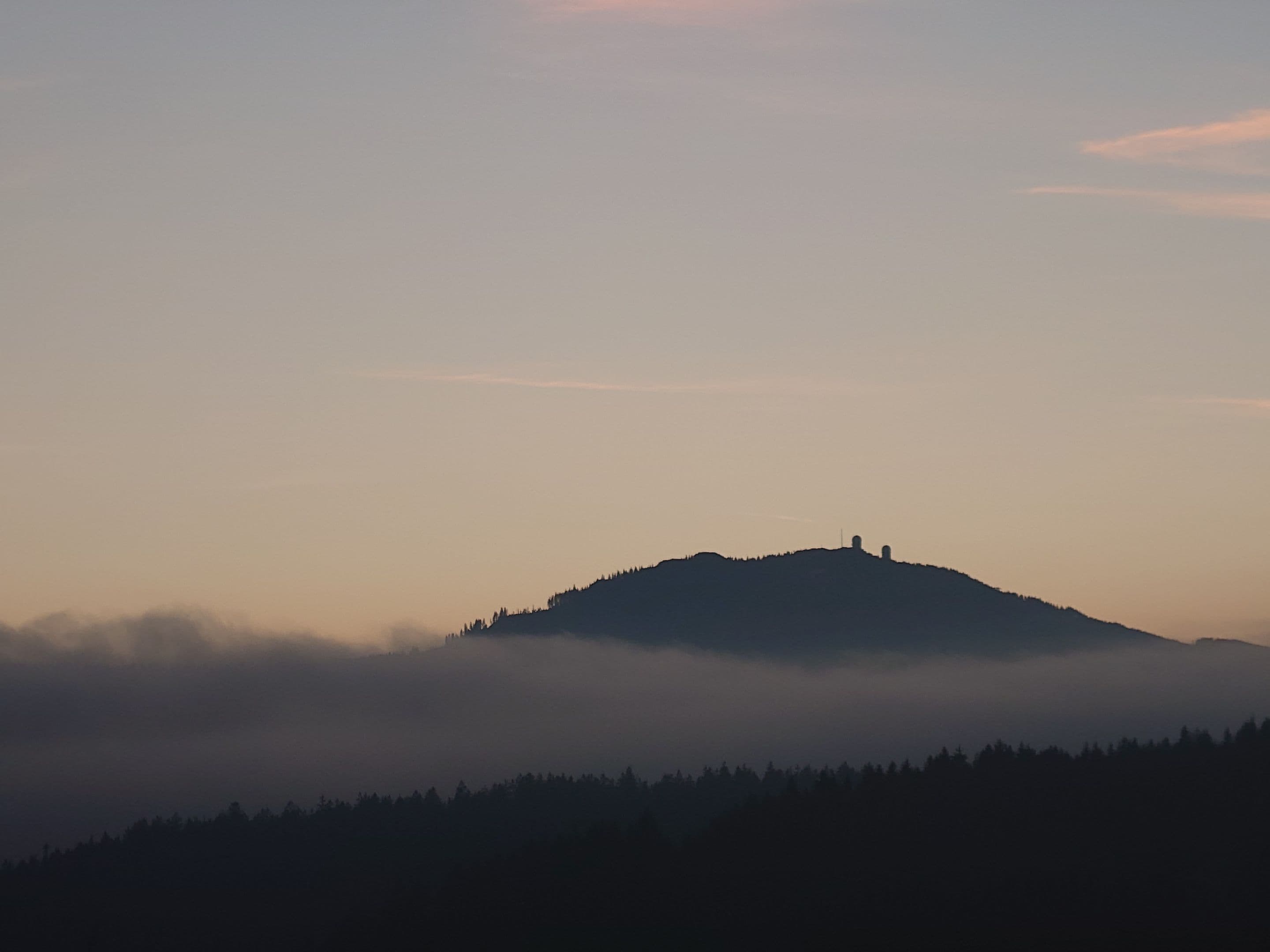 Pancíř peak with its lookout tower above a sea of clouds