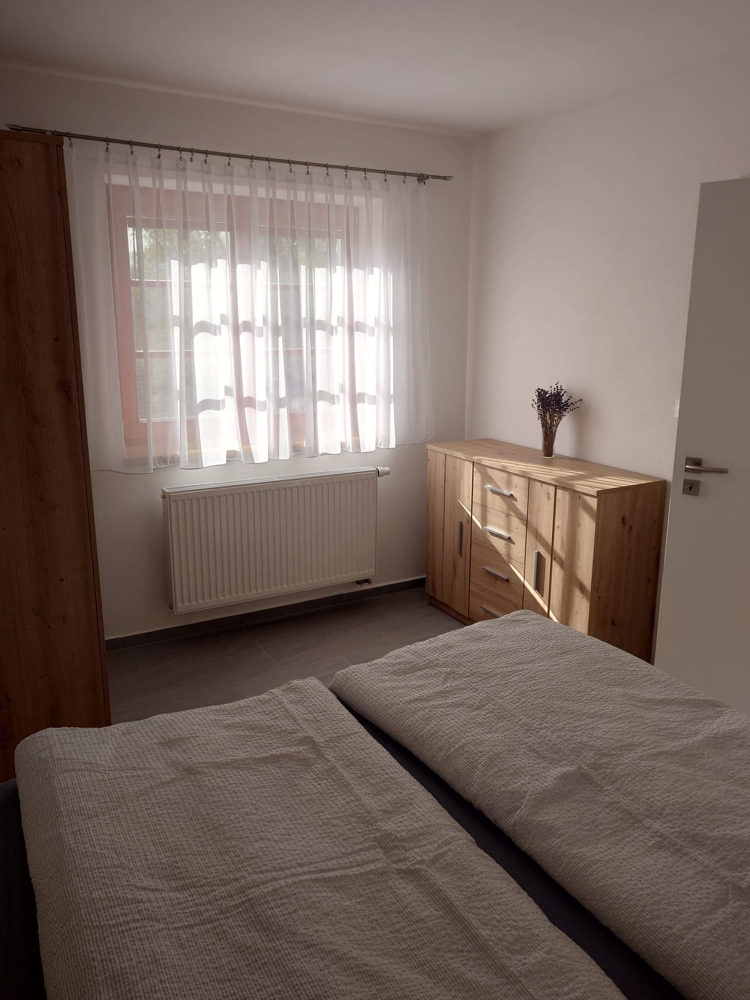 Bedroom with double bed and wooden furniture